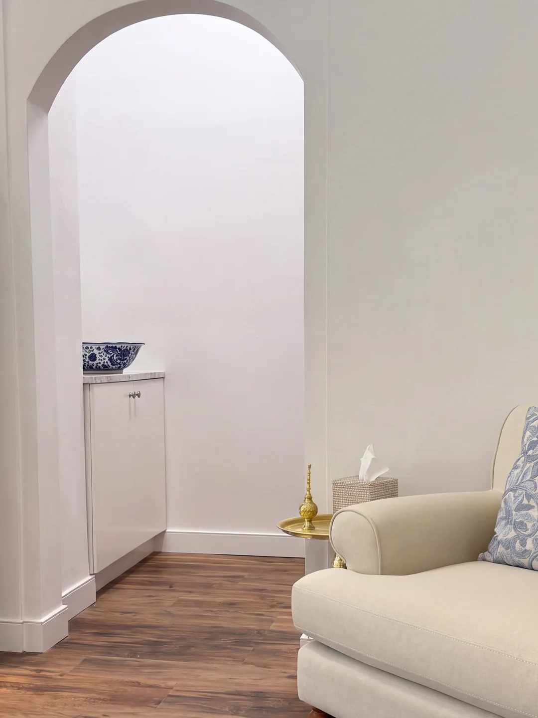 The RRYL studio: an arched doorway and a linen armchair